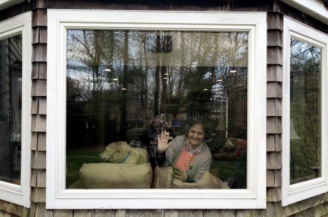 The photographer captures her grandmother, Nancy Hoit, who is sitting in the window of her house in Hingham, Mass., on April 22, 2020. 