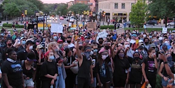 Many individuals hold signs that show their support for the Black Lives Matter movement during a recent demonstration in downtown Iowa City. 