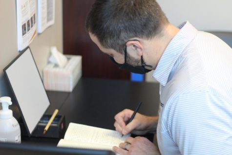 Adam Melichar, a counselor at Maize South High School, writes a letter of recommendation for a senior. In the years he has been teaching and counseling, he has written hundreds of unique letters for his students.
