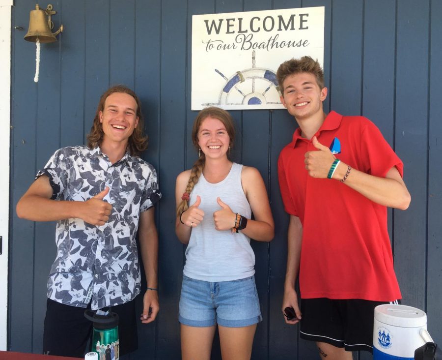 Jeffery Wright, Isabelle Koerner, and Nate DeGregorio stand in front of a welcome sign at the boat house at at Hopkinton (Mass.) State Park.  
