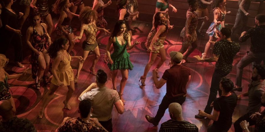 “In the Heights fills the screen with dancers, and features  Melissa Barrera (in green) as Vanessa. 