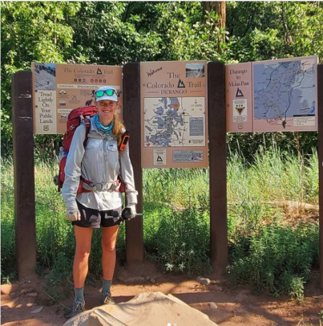Isabella Namaksy stands before a map of the Colorado Trail after completing her five-week solo hike.