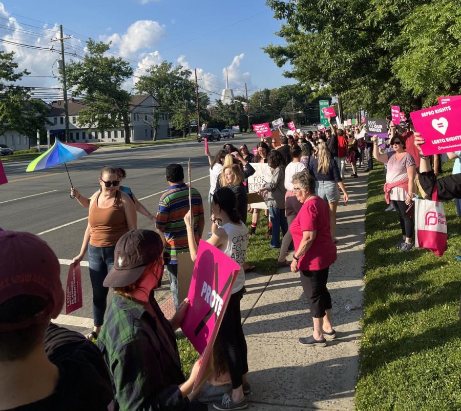 People in Cherry Hills, N.J., stand alongside Kings Highway, urging passing cars to honk in protest the Supreme Courts latest ruling on Roe vs. Wade on June 24, 2022.