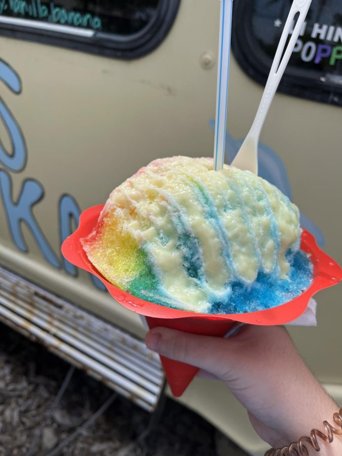Kat’s Kau Kau, the first shaved ice truck in Kona, serves its popular strawberry, vanilla, and banana flavor combination with lychee topping. 

