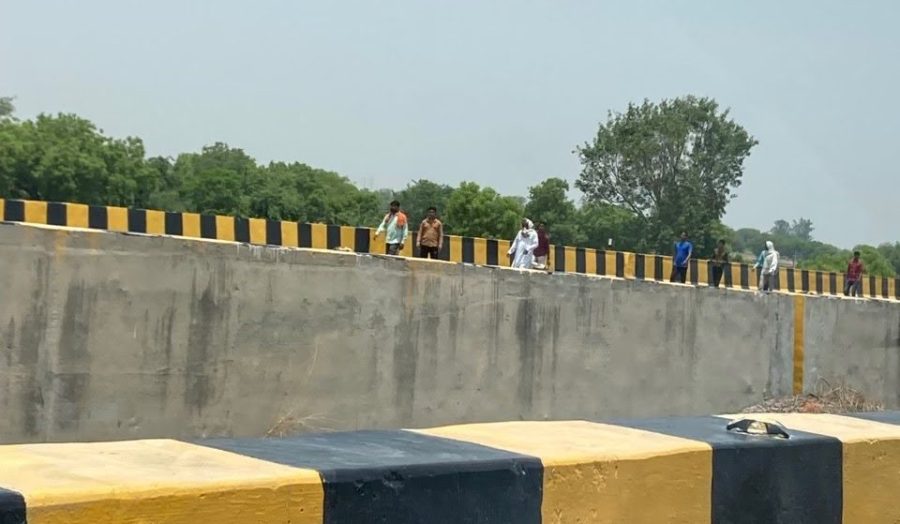 Men gather on the Delhi-Agra highway to block incoming traffic.