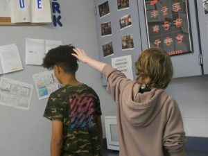 A CURIOUS ACTION. Two Sequoyah Scribe models illustrate a common problem at Sevier Middle School; students touch African American students’ hair without their permission. Many believe this is an invasion of privacy.
