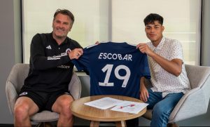 Olger Escobar (right) holds up his new New England Revolution jersey along with Curt Onalfo, the team's technical director, after signing his pro contract July 26, 2023.