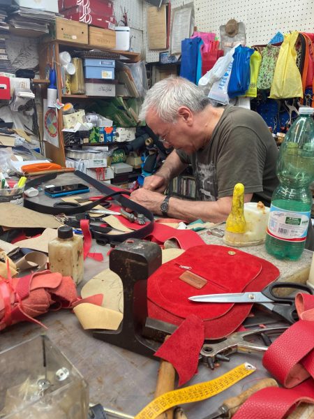 The owner of the Ciuffetti Giuseppe leather specialty shop in Rome works on making a belt for a customer to bring back to the United States.
