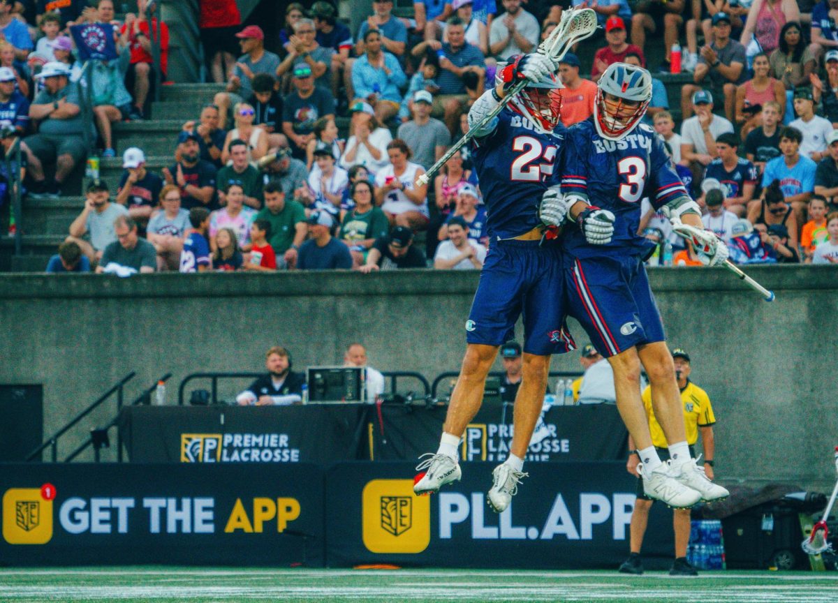 Chris Aslanian (right) and Ryan Drenner of the Boston Cannons celebrate a goal during a 14-10 win against the Philadelphia Waterdogs on July 6, 2024, at Harvard Stadium in Premier Lacrosse League action.