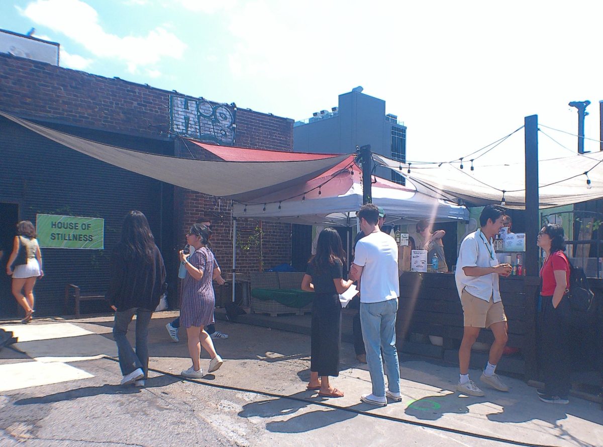 Sat, Aug 10, 2024, attendees stand waiting for their drink order while others enter inside the cool air conditioner titled ‘‘House of Stillness’’ for the next program at the Elm Foundation’s The Boiler venue in Greenpoint, Brooklyn, New York. 