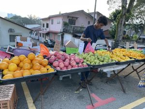 A shopper checks out the items at a Malaysian night market.