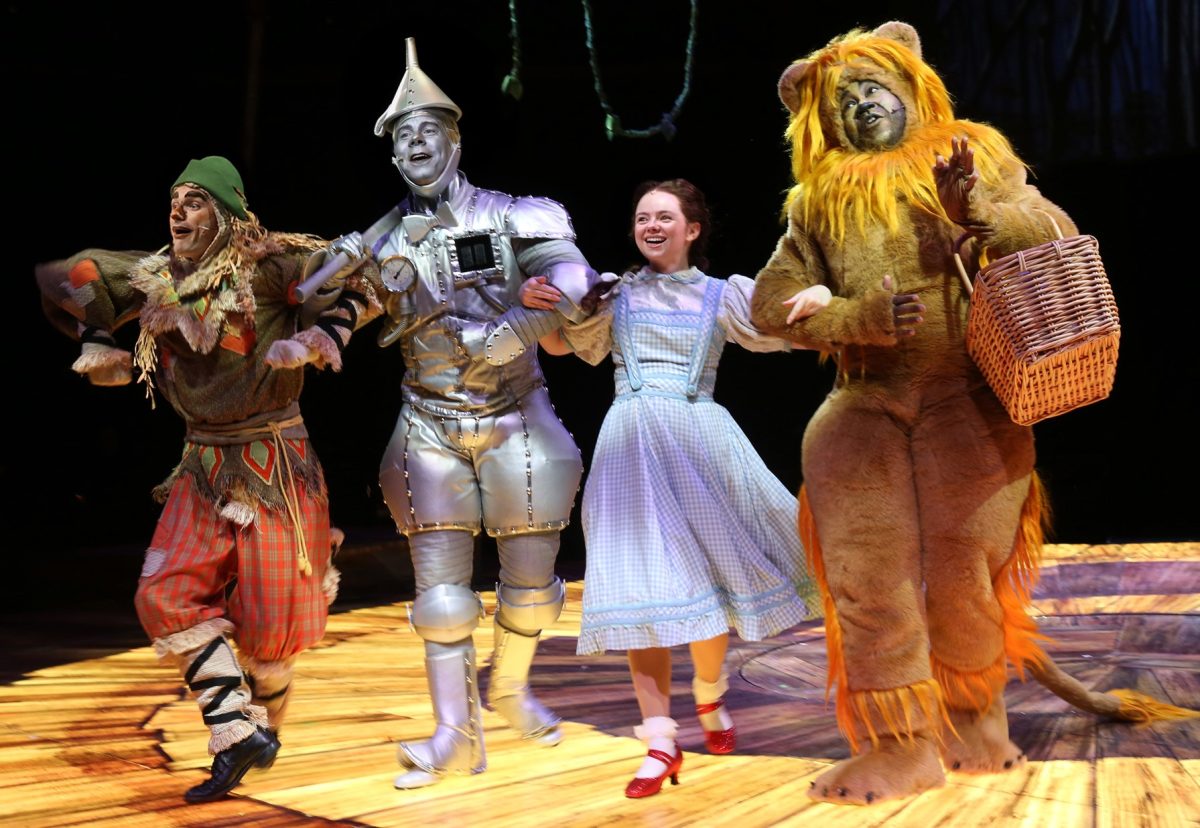 Ethan Carlson (Scarecrow), Sean Bell (Tin Man), Bridget Delaney (Dorothy Gale), and E. Mani Cadet (Cowardly Lion) in “The Wizard of Oz” on stage at North Shore Music Theatre through July 20, 2025. (Photo courtesy of Paul Lyden)